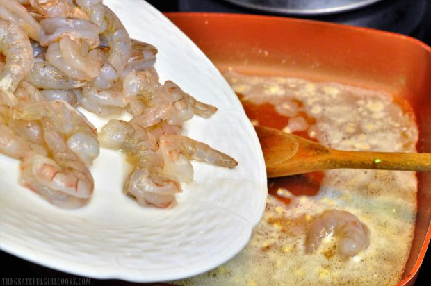 Seasoned shrimp are added to the butter and lemon shrimp scampi sauce.