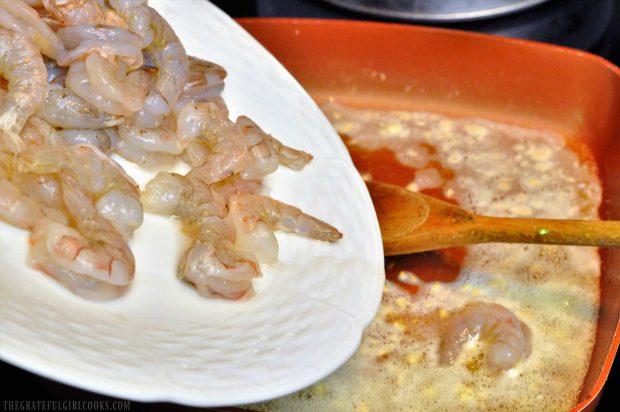 Seasoned shrimp are added to the butter and lemon shrimp scampi sauce.