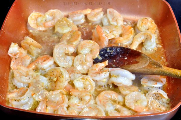  All of the seasoned shrimp are cooking in skillet.