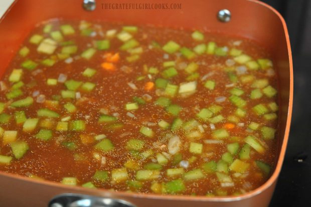 Carrots and celery cooking in broth for soup