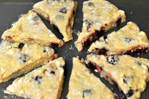 Blackberry scone wedges placed on cookie sheet to bake