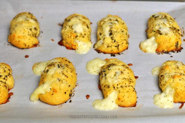 Easy Cheesy Garlic Crescent Rolls are baked and cooling on parchment paper.