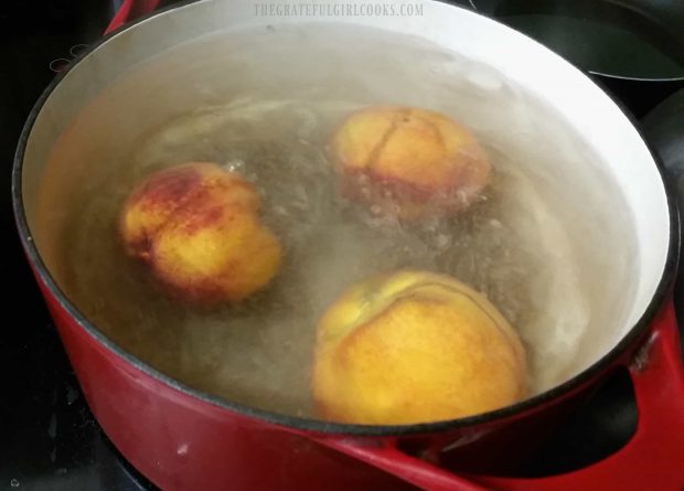 Peaches are immersed in boiling water to loosen peel.