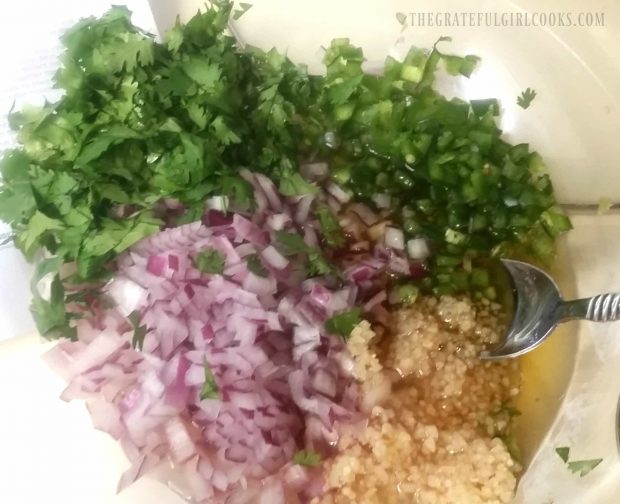 Cilantro, garlic, red onion, jalapenos and other ingredients used to can peach salsa.