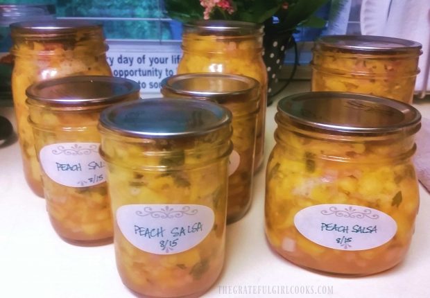 Finished jars of peach salsa are cleaned, labeled and are now ready to store.