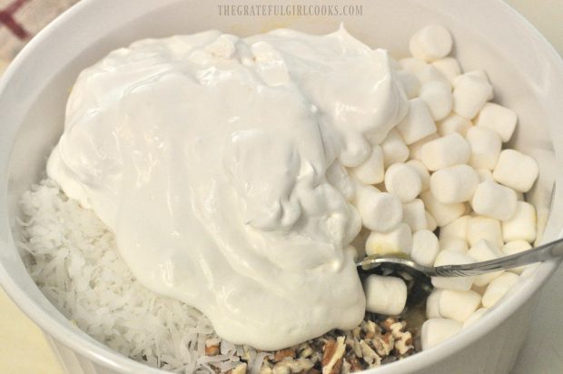 Whipped topping is added to Piña Colada Fluff Salad.