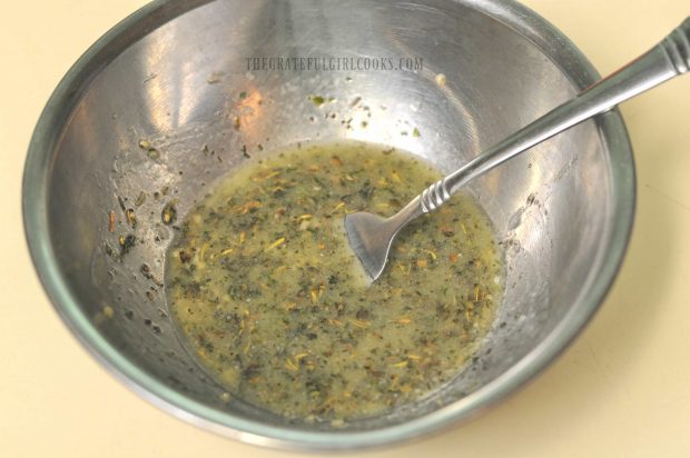 Marinade is mixed for dressing the strawberry avocado spinach salad.