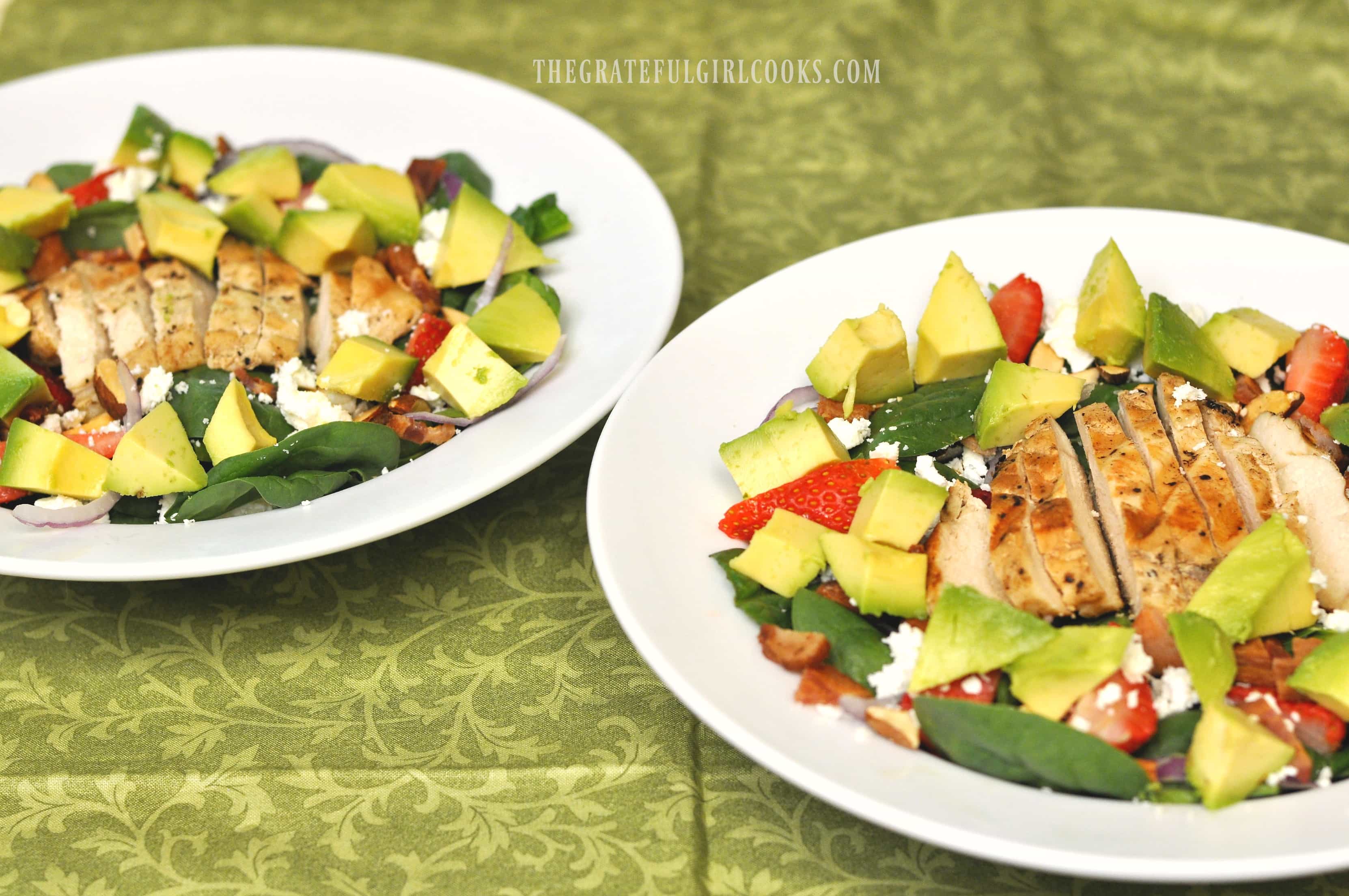 Two strawberry avocado spinach salads with grilled chicken ready to eat!