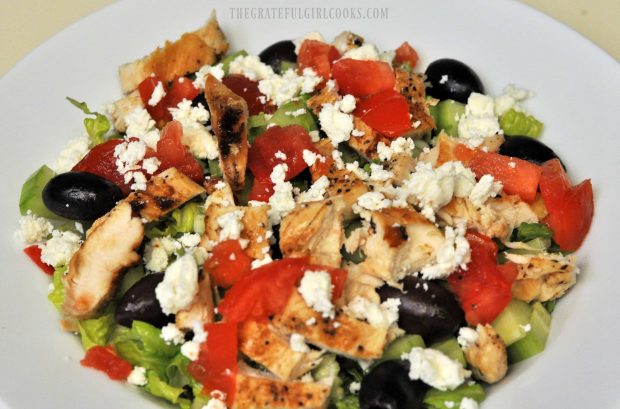 Chopped tomatoes and feta cheese is added to the chopped Greek chicken salad.