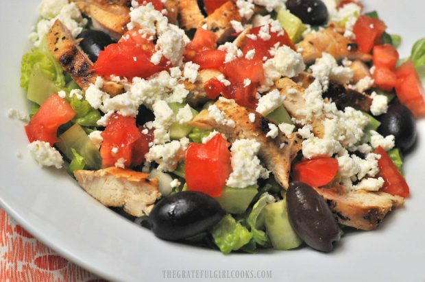 Another close up picture of a chopped Greek chicken salad in white bowl.