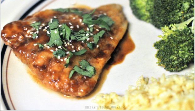 When cod with hoisin glaze is done baking, it's topped with cilantro and sesame seeds and served.