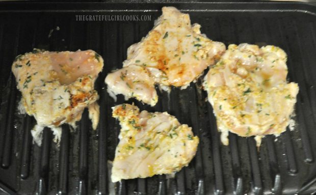 Lemon Rosemary Chicken Breasts are grilled after marinating.