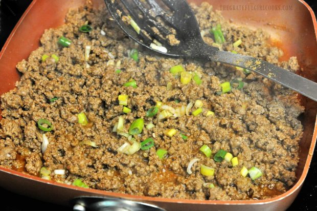 Cooking ground beef and onions to stuff into pasta shells.