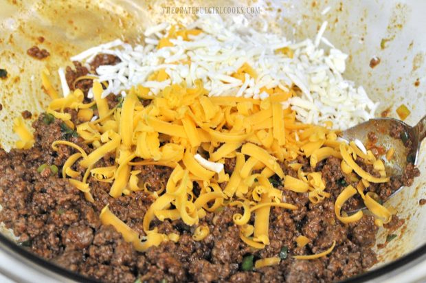 Grated cheeses are added to ground beef for the stuffed pasta shells.