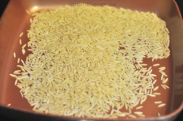 Orzo is lightly toasted in a dry skillet until golden brown.
