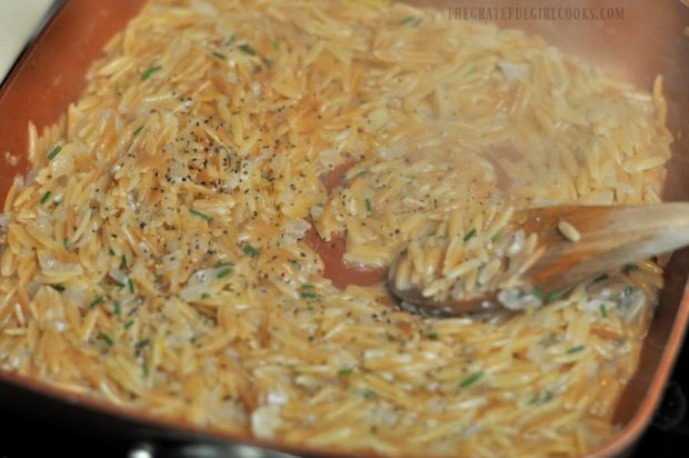 Orzo is seasoned with salt and pepper while it cooks.