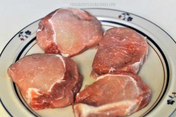 Fat is trimmed off boneless pork chops before cooking.