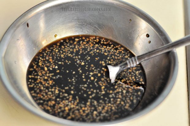 Marinade for honey garlic pork chops is mixed in bowl.