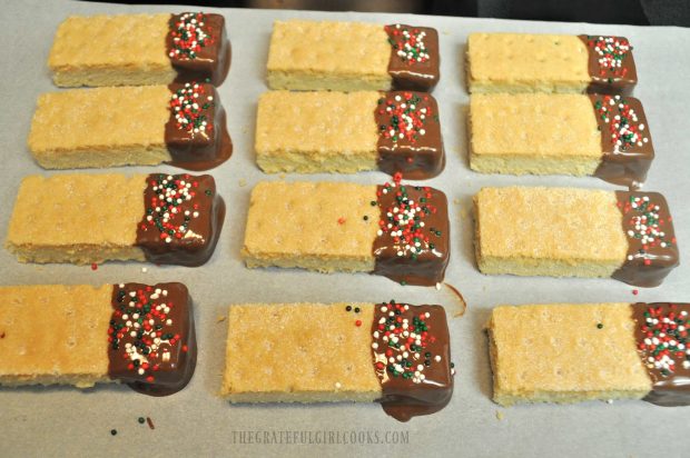 Chocolate Dipped Shortbread Cookies resting on parchment paper.