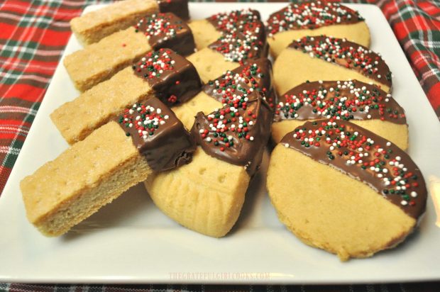 Chocolate Dipped Shortbread Cookies, covered with colored sprinkles, on a white plate.