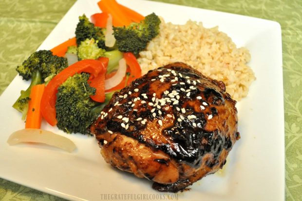 Hoisin Sriracha Chicken, served on plate with brown rice and steamed vegetables on the side.