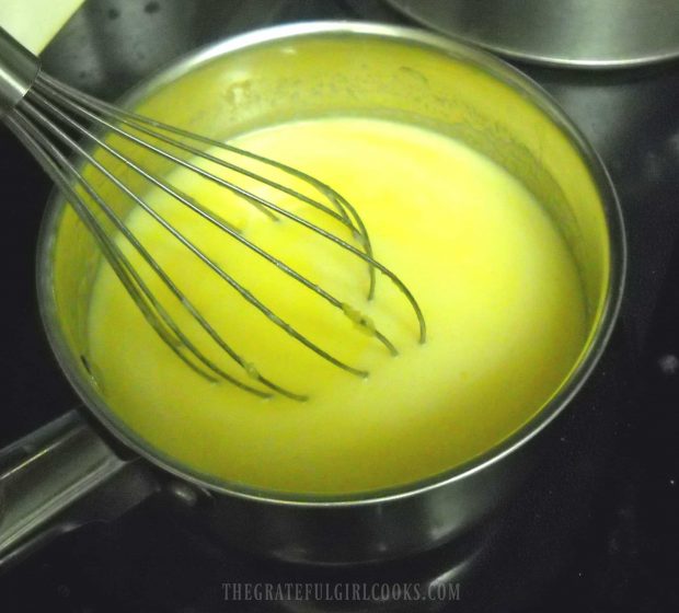 The lemon curd is continually stirred while cooking, until it thickens.