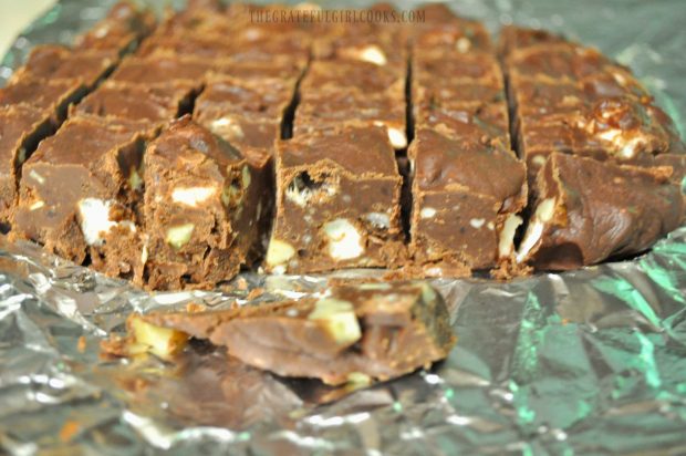 The microwave rocky road fudge is cut into small pieces to serve.