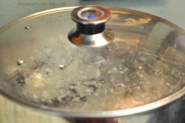 Jars of peach jam processing in water bath canner