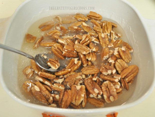 Pecan halves are added to brittle mixture and microwaved.