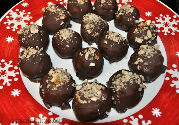 Pecan Pie Truffles are garnished and ready to serve on a red Christmas plate.