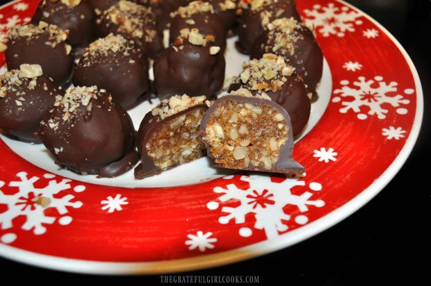 Pecan pie truffle is cut in half to show the inside, full of yummy pecan pieces!