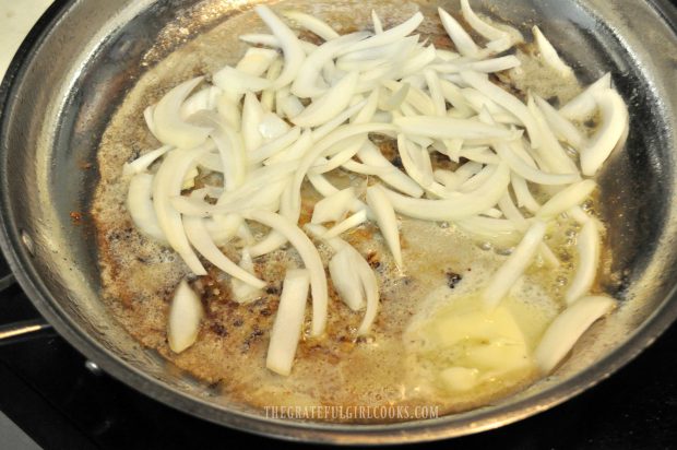 Onion slices are cooked in butter for smothered pork chops.