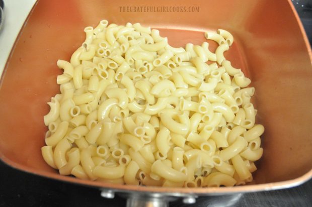 Macaroni noodles are cooked before adding cheese sauce.