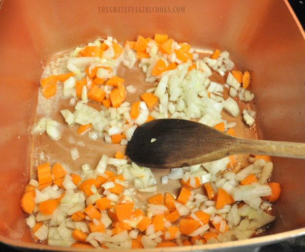 Carrots and onions are cooked for chicken wild rice soup.