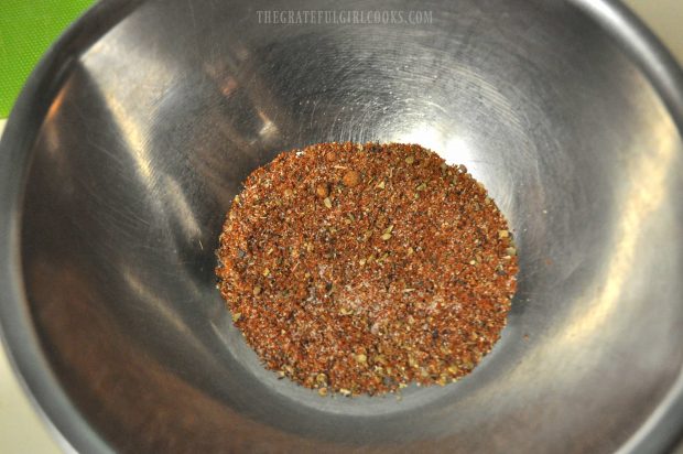 Spices mixed in bowl to coat chicken for the chicken fajita rice bowl.