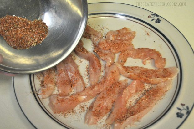 Spices are added to chicken breast strips for the chicken fajita rice bowl.