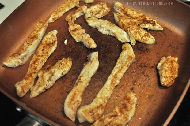 Seasoned chicken strips are cooked in skillet for the chicken fajita rice bowl.