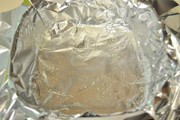 Dish is covered with foil and sprayed with non-stick spray for microwave rocky road fudge.
