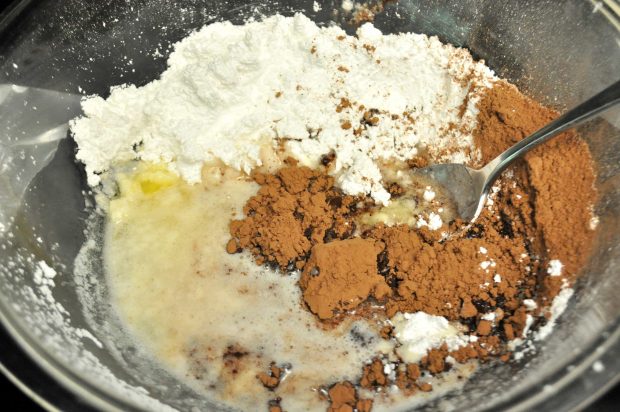 Butter has melted in the microwave with other ingredients in bowl for fudge.