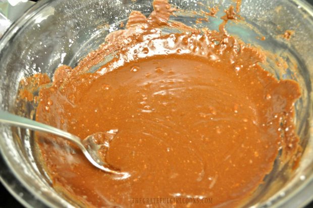 Ingredients for microwave rocky road fudge are stirred after cooking.
