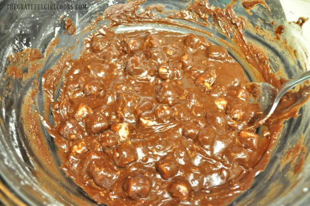 Mixing the ingredients together in a bowl, for microwave rocky road fudge. 