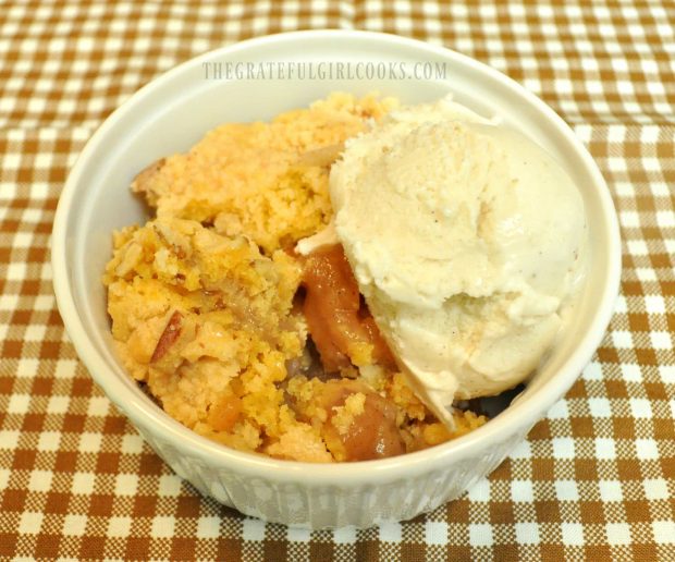 Karen's Delicious Apple Cobbler is serving in ramekin with a scoop of ice cream.