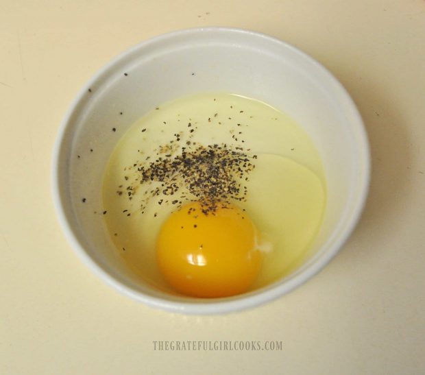 Egg, water and salt and pepper, in a ramekin before cooking in microwave.