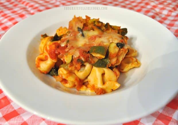 Tortellini and zucchini baked casserole in white serving bowl