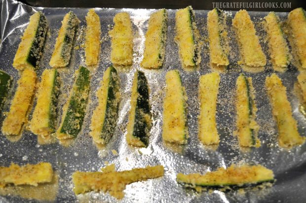 Parmesan zucchini fries are placed in single layer onto baking sheet to bake.