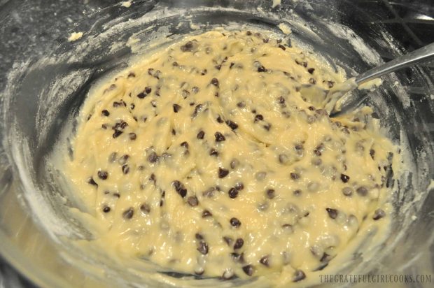 Muffin batter with chocolate chips in clear mixing bowl