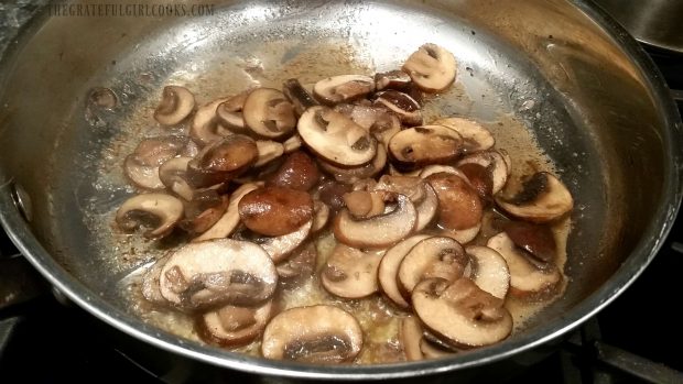 Cooked mushrooms in a metal skillet