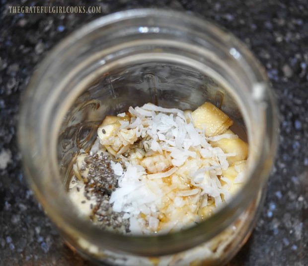 Oats, chia seeds, coconut, bananas and maple syrup are placed in a mason jar.