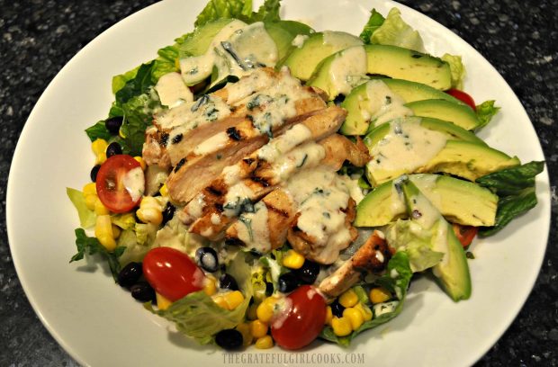 The Southwest chicken salad is drizzled with salad dressing, and is ready to eat.