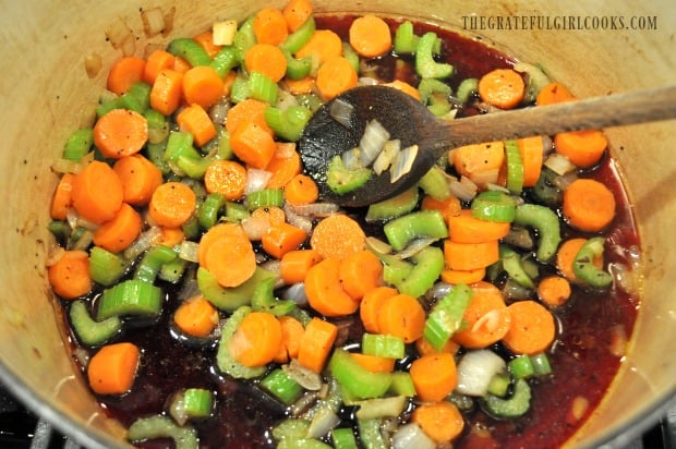 Cooking onions, celery, wine and carrots in large pot